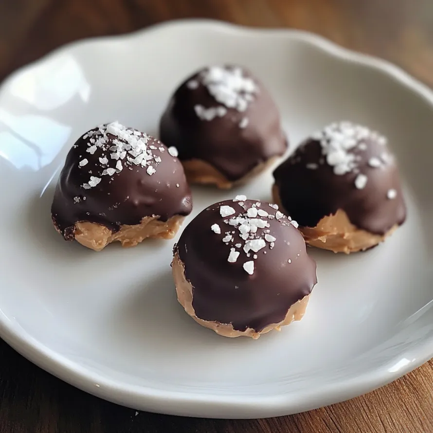 A plate of chocolate covered peanut butter balls.